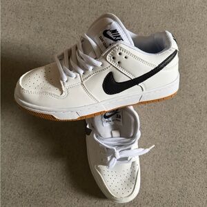 Nike White Low-Top Sneakers with Black Swoosh and Gum Outsole